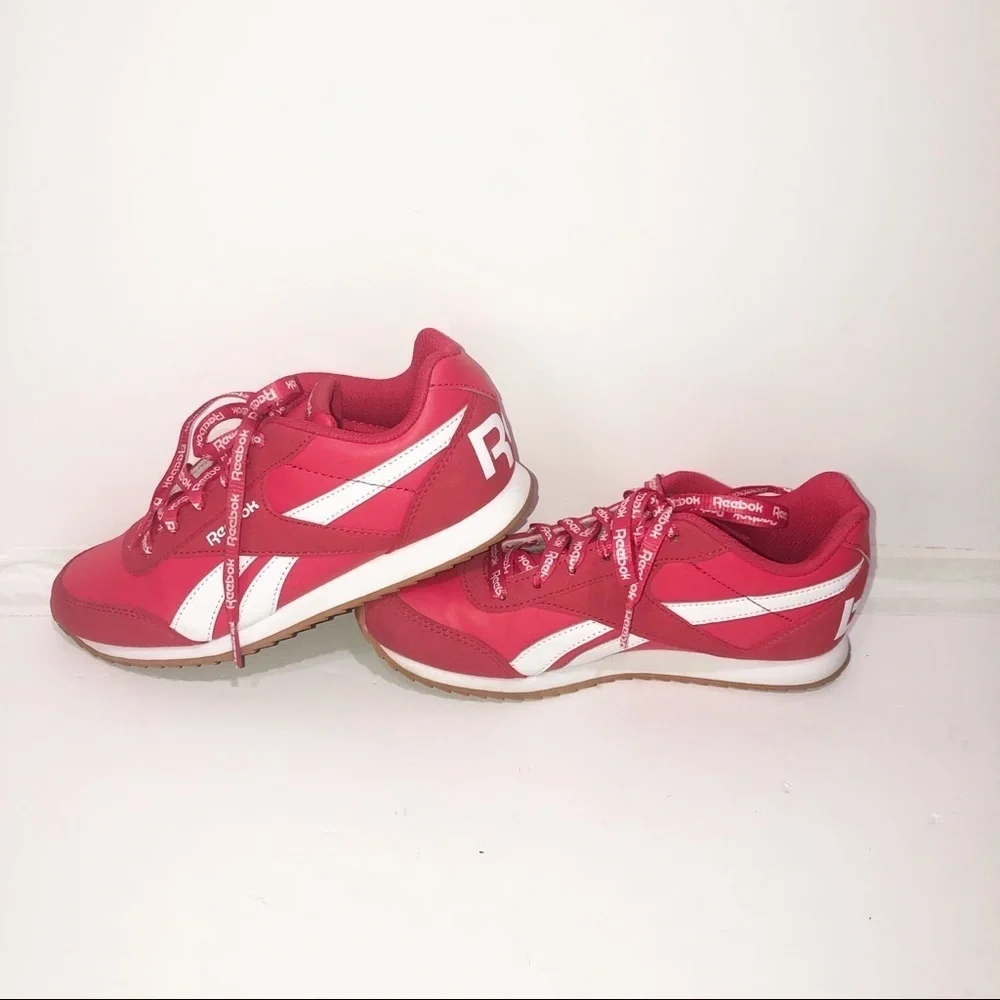 Reebok red classics with repeating logo strings.